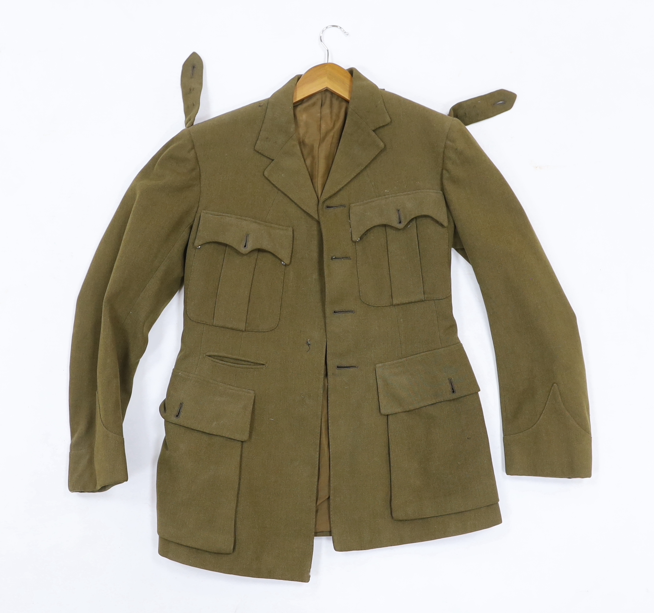 Eight British military uniform blouses/jackets, including two with Royal Sussex Regiment Cinque Ports shoulder insignia, a Queen’s A.C.F. example, etc.